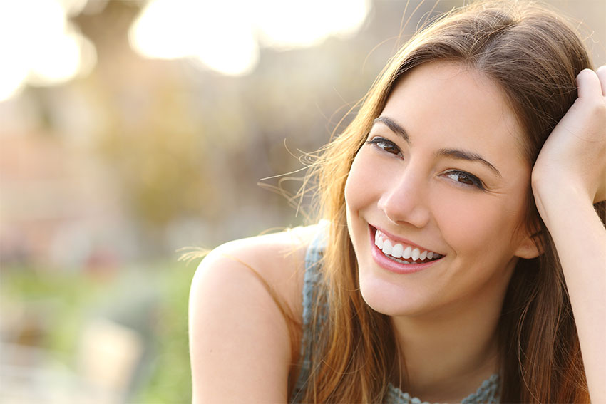 attractive young woman leaning her head on her hand