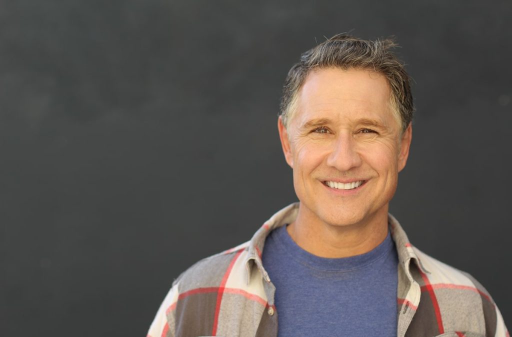 mature man with a natural looking smile with a dental bridge